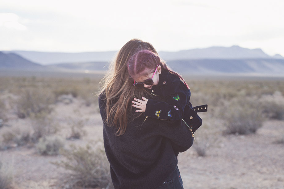 Corri McFadden holds daughter, Zelda in the desert in Las Vegas.
