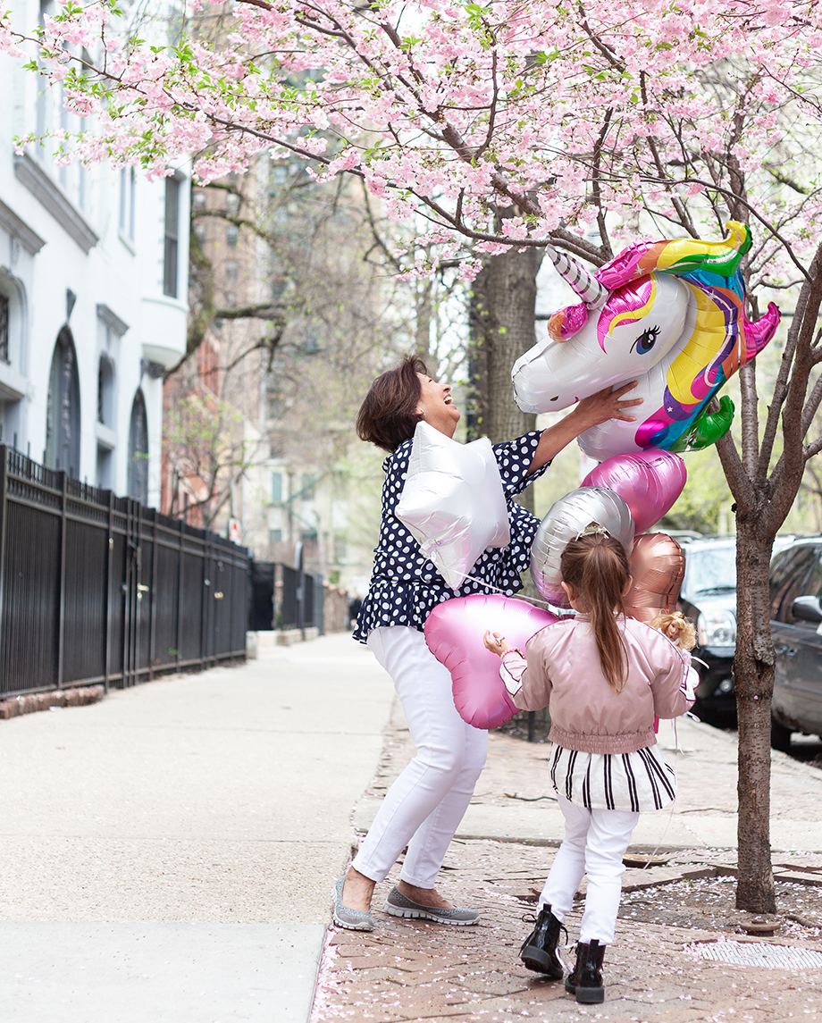Zelda of Glitter and Bubbles stands on the sidewalk with her nanny in Chicago. 